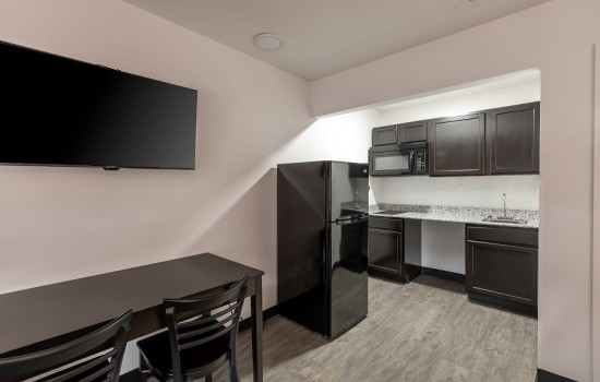 Welcome To Suburban Extended Stay - Kitchen and Dining Area